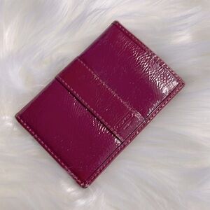 Coach Wallet in a burgundy patent leather in used condition
